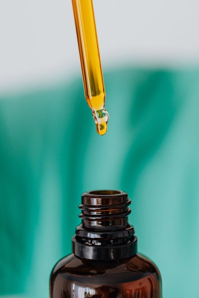 pipette with seed oil for adhd being drawn from a bottle